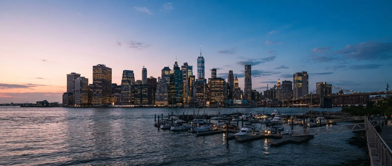 Lower Manhattan skyline at dusk across the East River